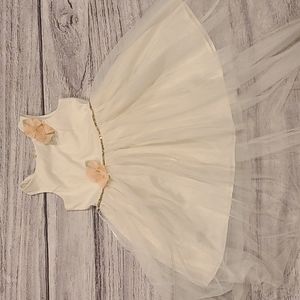 Girl's formal dress with cream shell, decorative peach flowers, gold and lace